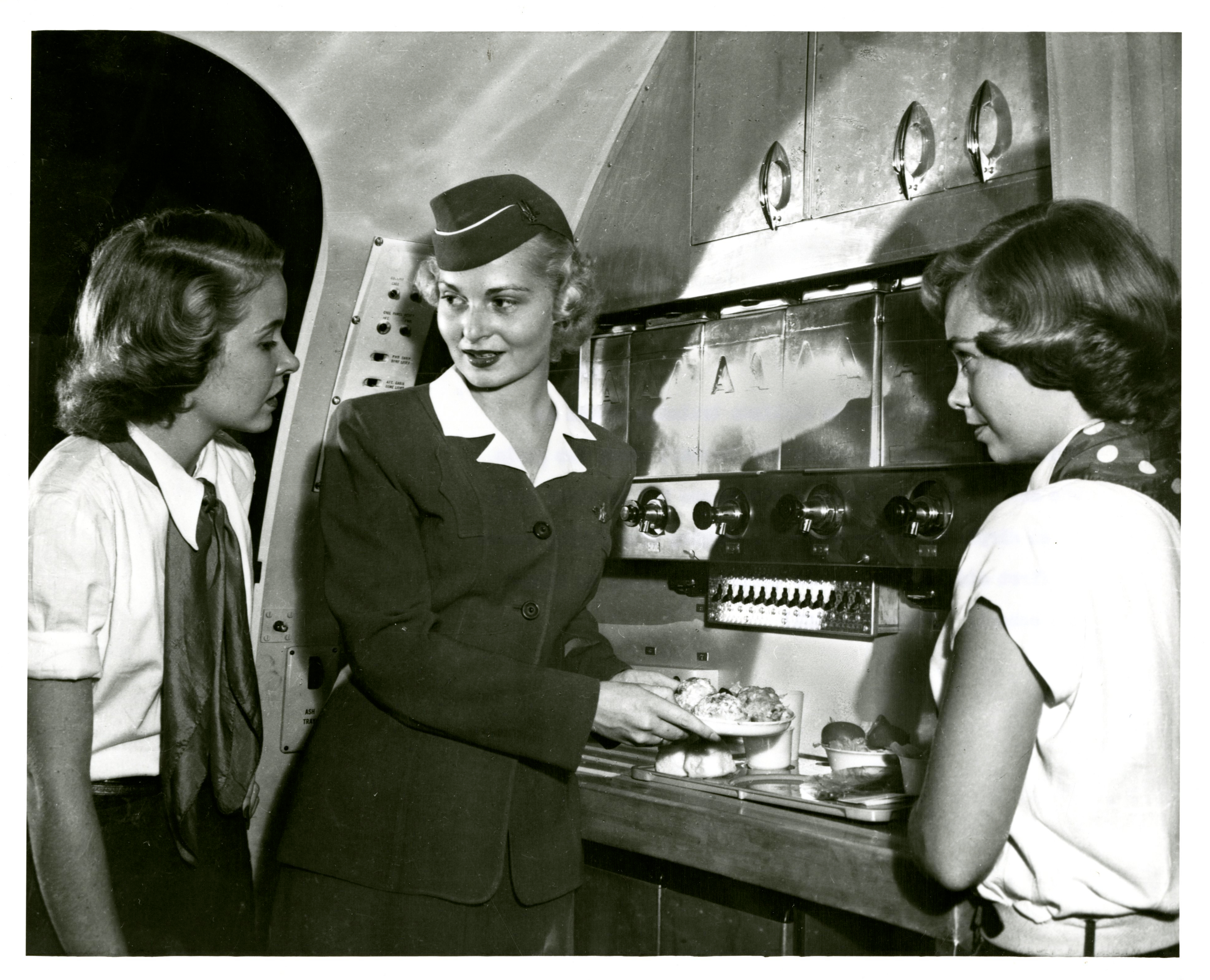 A photograph of three stewardesses in training.