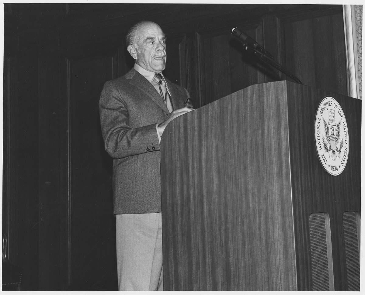 Image of Frank Capra standing at podium.