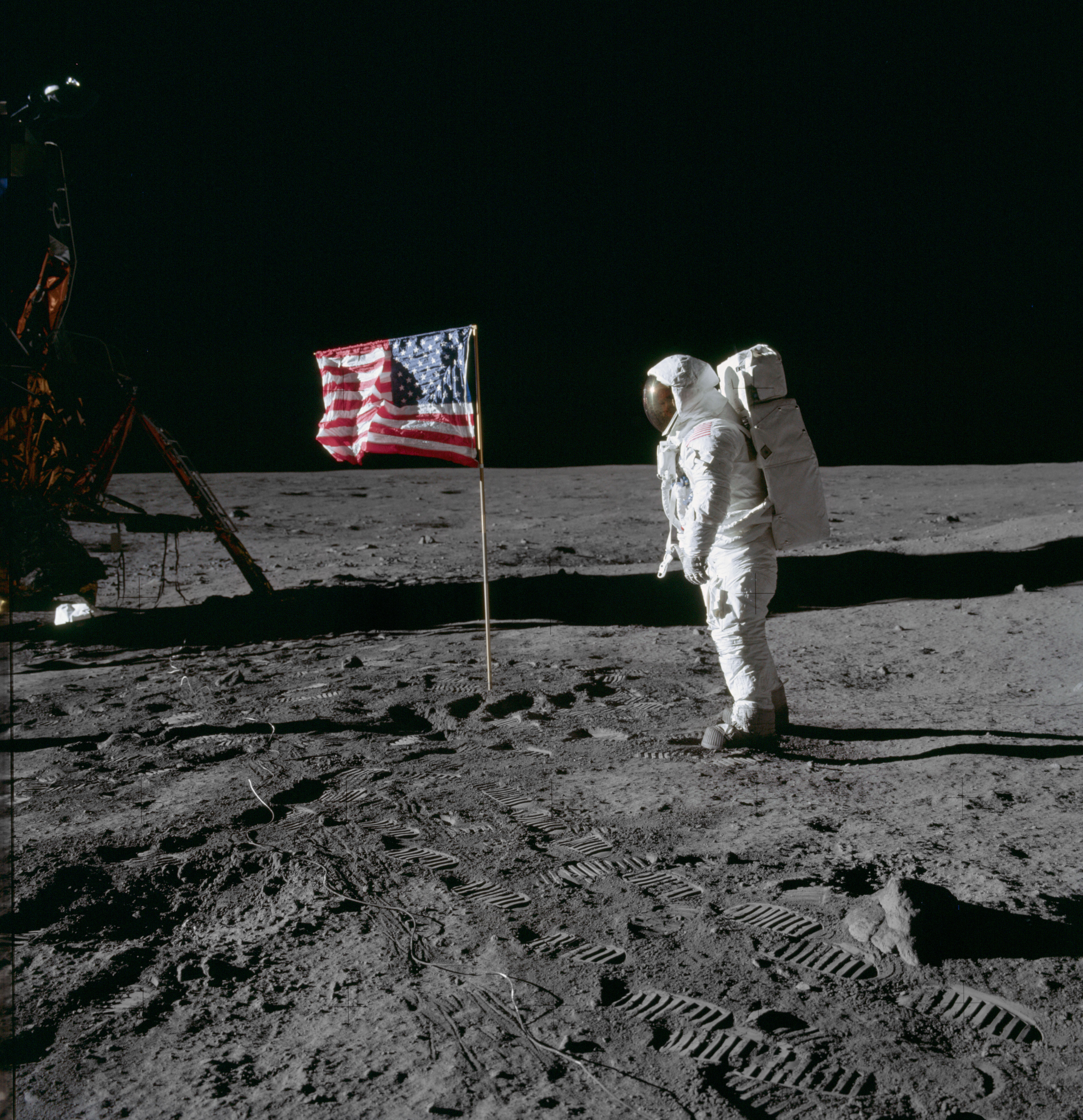 Edwin Aldrin looks at US flag planted on the moon