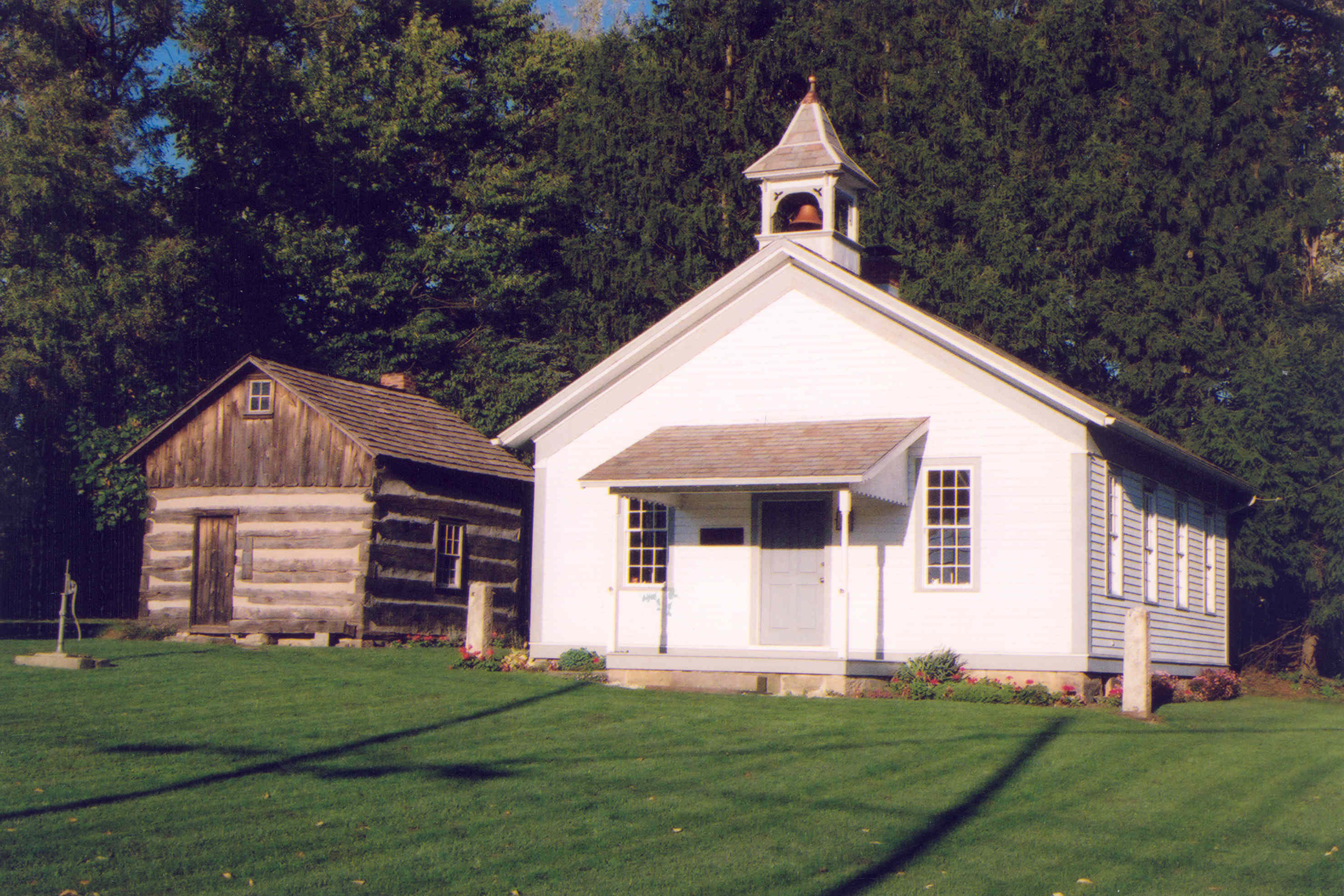 image of school house and cabin.
